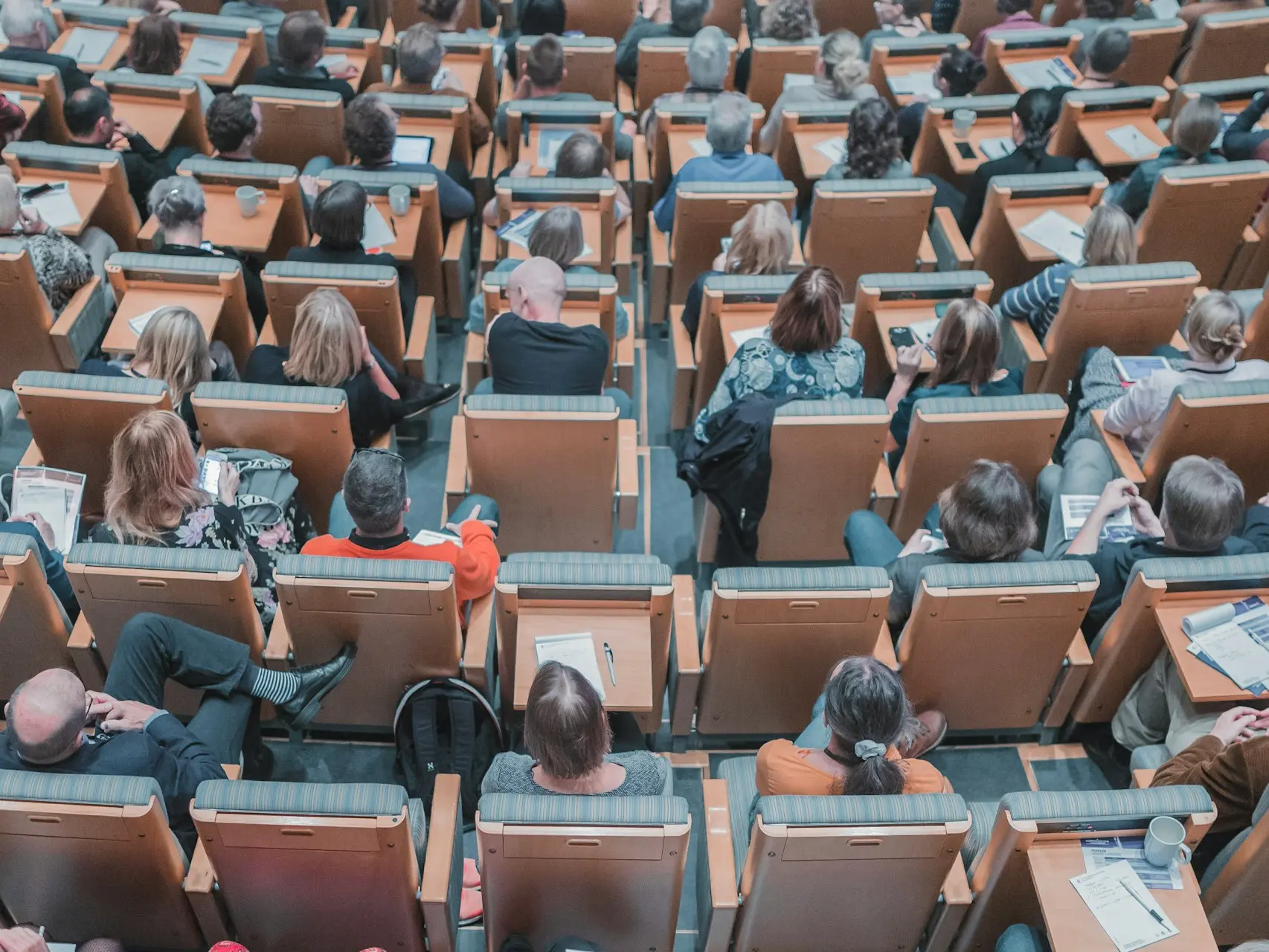 high-angle photography of group of people sitting at chairs